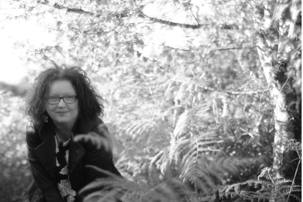 Catherine Ronan in a nature scene smiling at the camera.